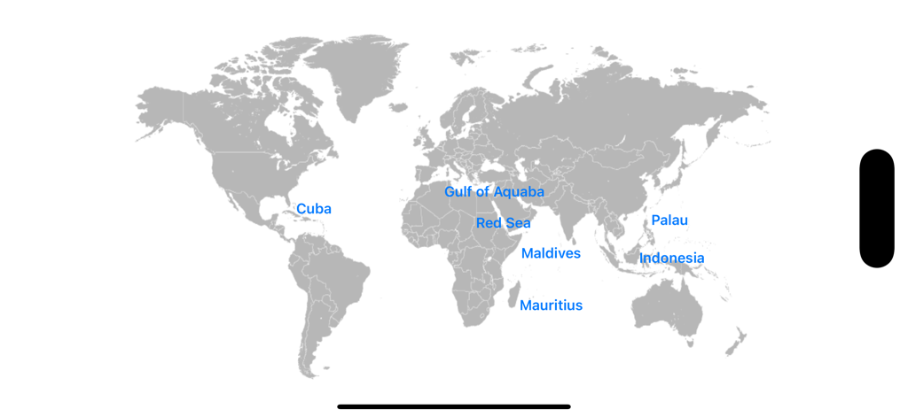 World map in the Reef Guide app showing selectable diving regions like the Red Sea and Maldives