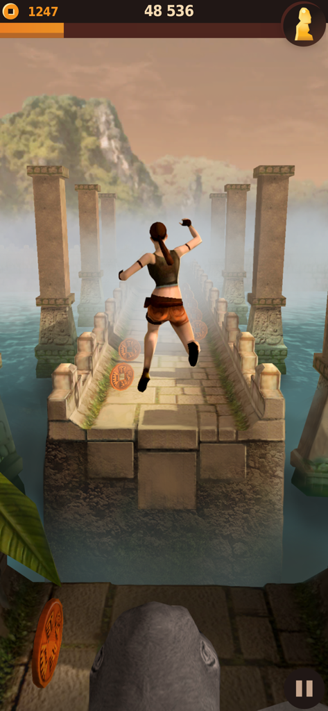 A character jumping over a gap on a stone bridge in the Tomb Runner Temple Raider mobile game