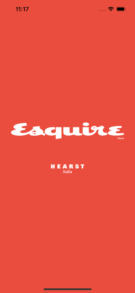 La schermata di avvio dell'app mobile Esquire Italia con il logo bianco di Esquire e il marchio Hearst Italia su sfondo rosso.