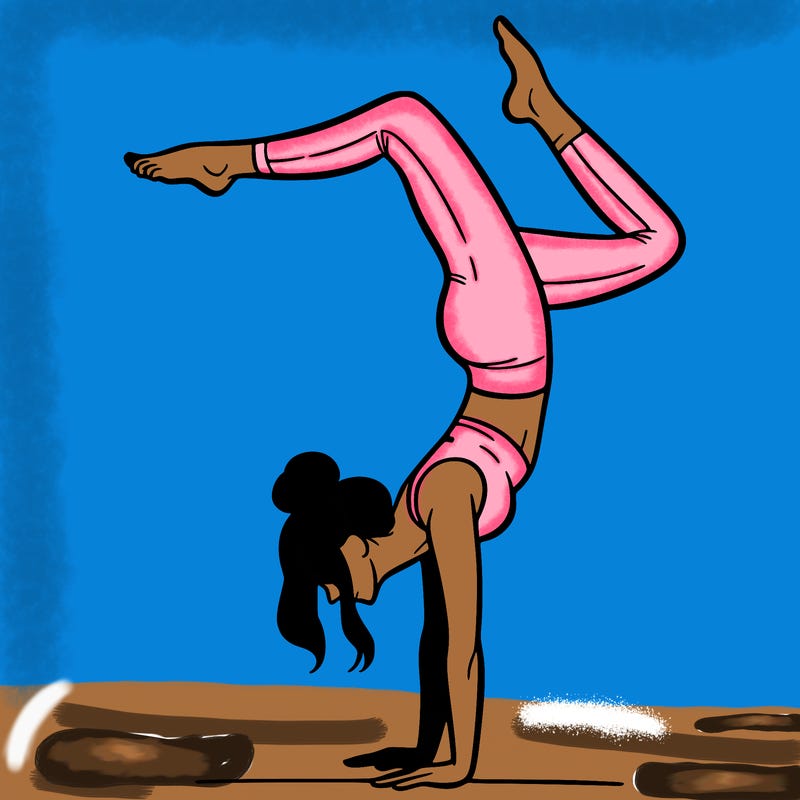 a woman doing a handstand