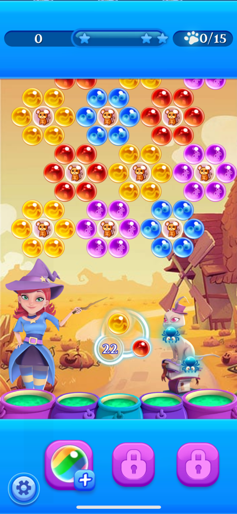 Stella the witch and her cat in a bubble shooting level with colorful bubbles and pumpkins
