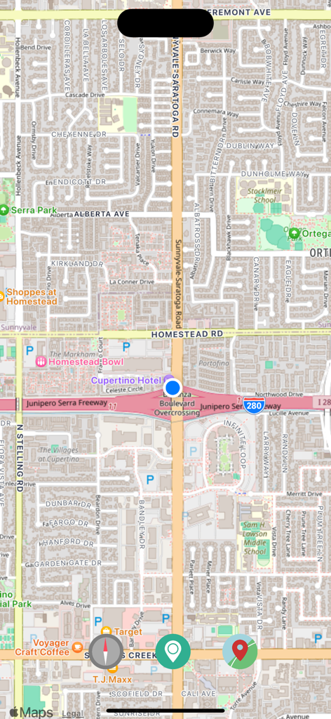 Una captura de pantalla de la aplicación OpenMaps que muestra un mapa urbano detallado con un punto azul para la ubicación actual.