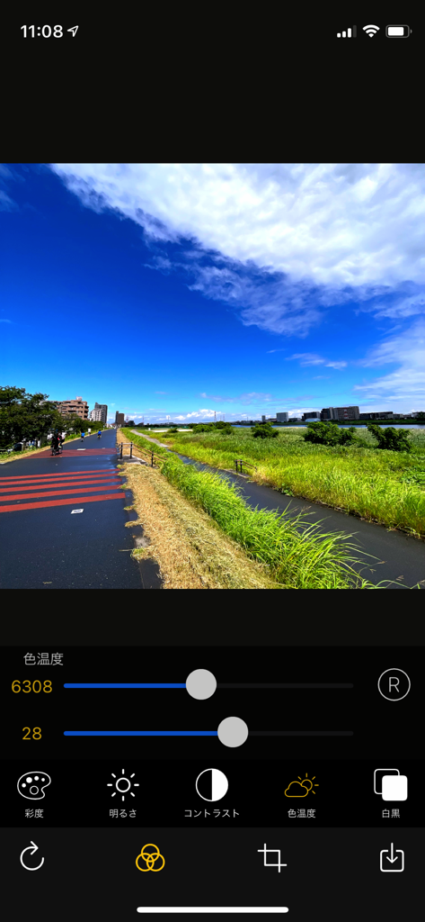 OneCam 2 app interface showing color temperature and manual photo editing adjustments on a landscape photo