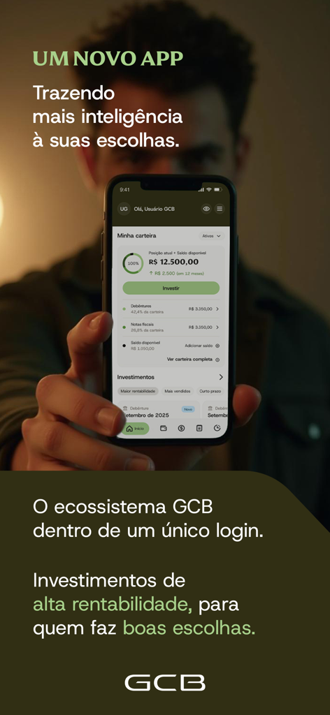 GCB Investimentos mobile app displaying an investment portfolio on a smartphone held by a user
