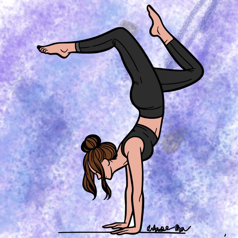 a woman doing a handstand