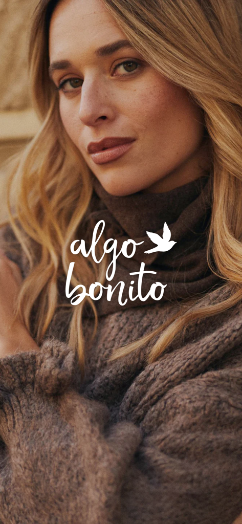 Woman wearing a brown knit turtleneck sweater with the Algo bonito brand logo and bird icon