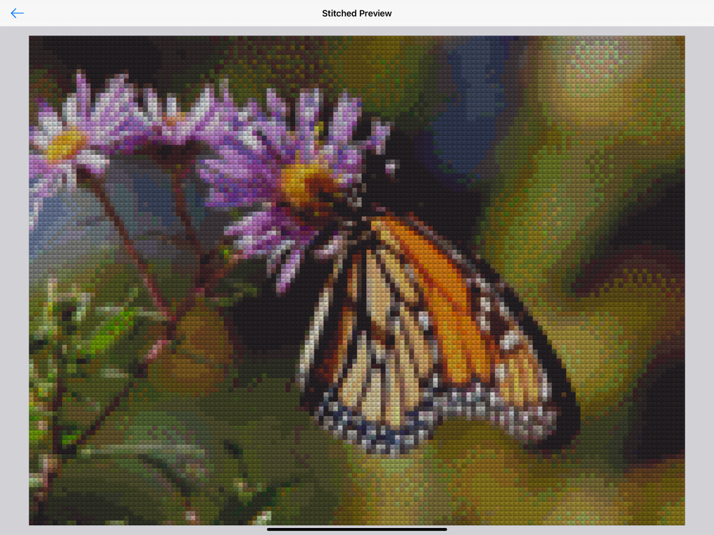 A stitched preview of a monarch butterfly on a flower generated by the Cross Stitch Creator app