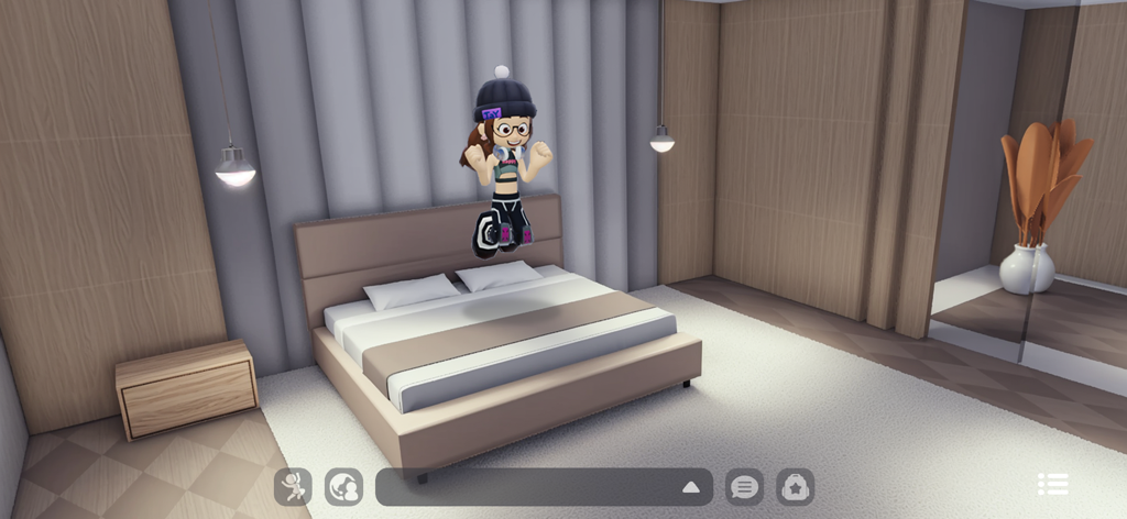 Livetopia: Party! - Un personnage sautant sur un lit dans une chambre moderne et élégante dans Livetopia Party.