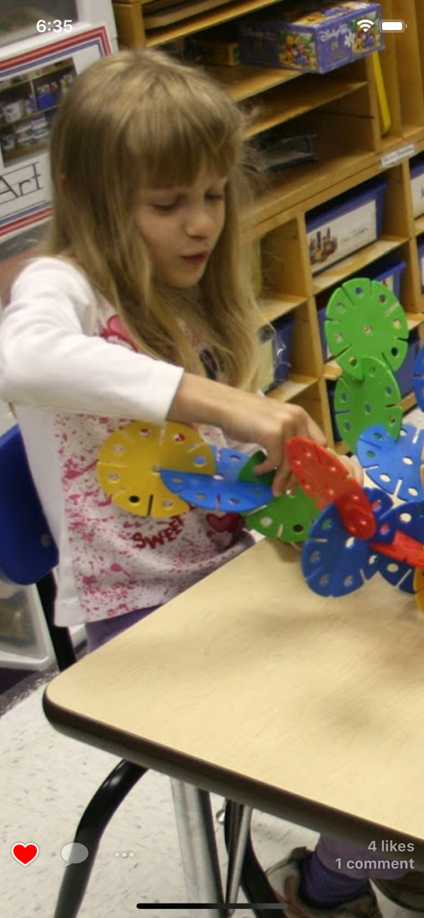 Homeroom Private Photo Sharing - Young student playing with construction toys in a classroom shown on the Homeroom app