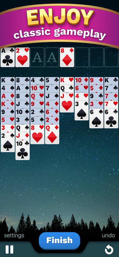 A game of Freecell Solitaire Cube featuring classic gameplay with cards arranged on a starry night forest background.