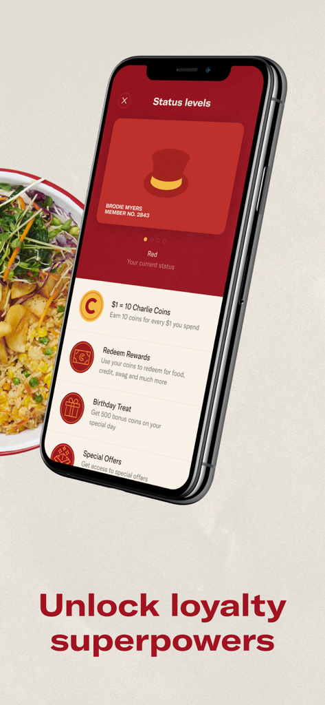 A mobile phone screen showing Chargrill Charlie's loyalty status levels and Charlie Coins rewards next to a bowl of grilled chicken and salad