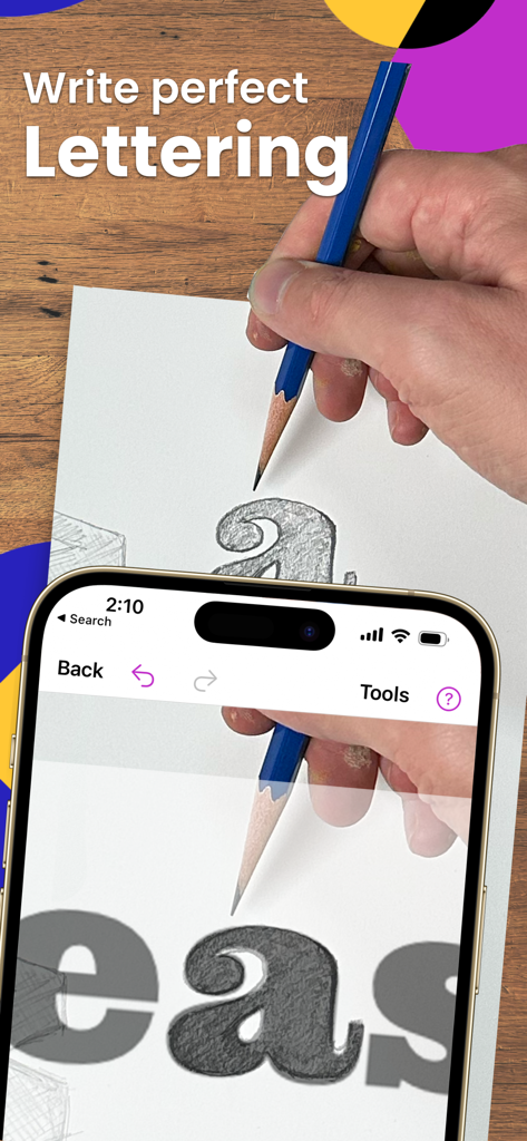 A person using the Da Vinci Eye AR app to trace perfect lettering onto paper with a pencil.