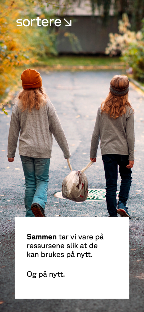 Sortere - Two young girls carrying a bag together for recycling on a paved path