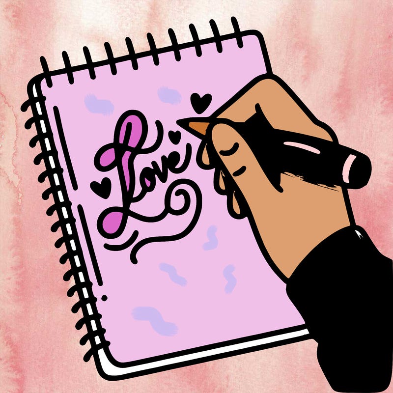a hand writing “love” in calligraphy on a notebook