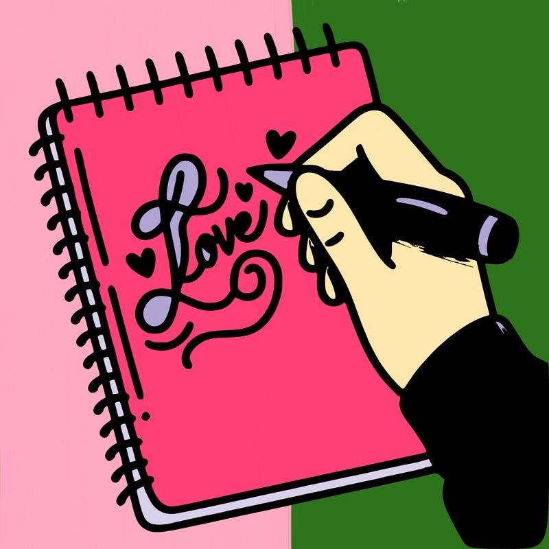 a hand writing “love” in calligraphy on a notebook