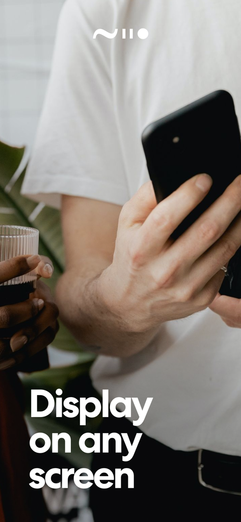 A person holding a smartphone with the Niio Art app and the text Display on any screen