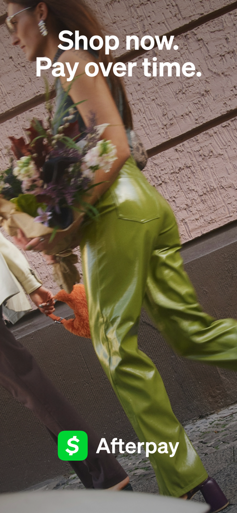 A fashionable woman walking with flowers featuring Afterpay logo and shop now pay over time text