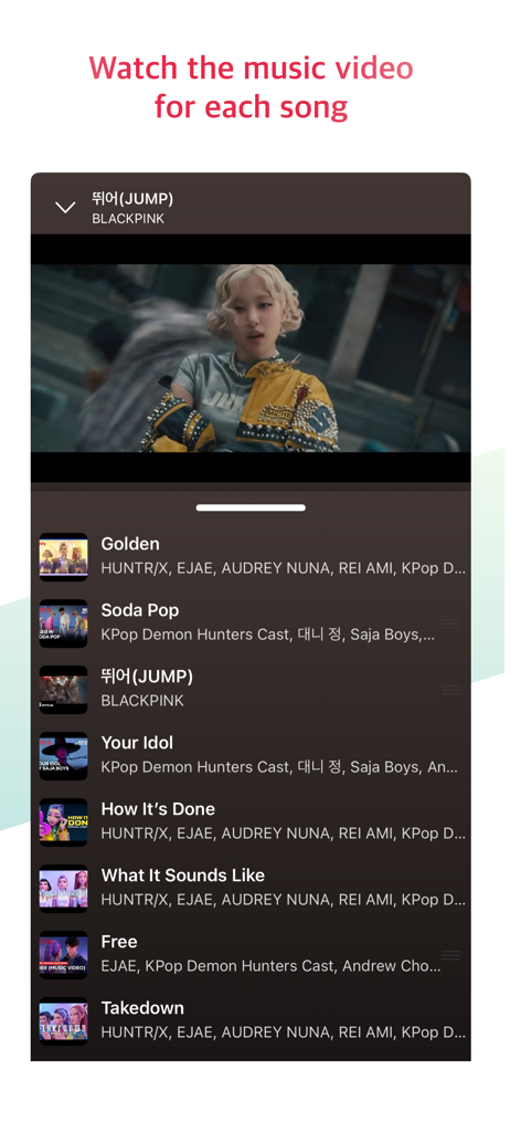 K-Pop Tube app interface showing a music video player with a playlist of K-pop songs below it.