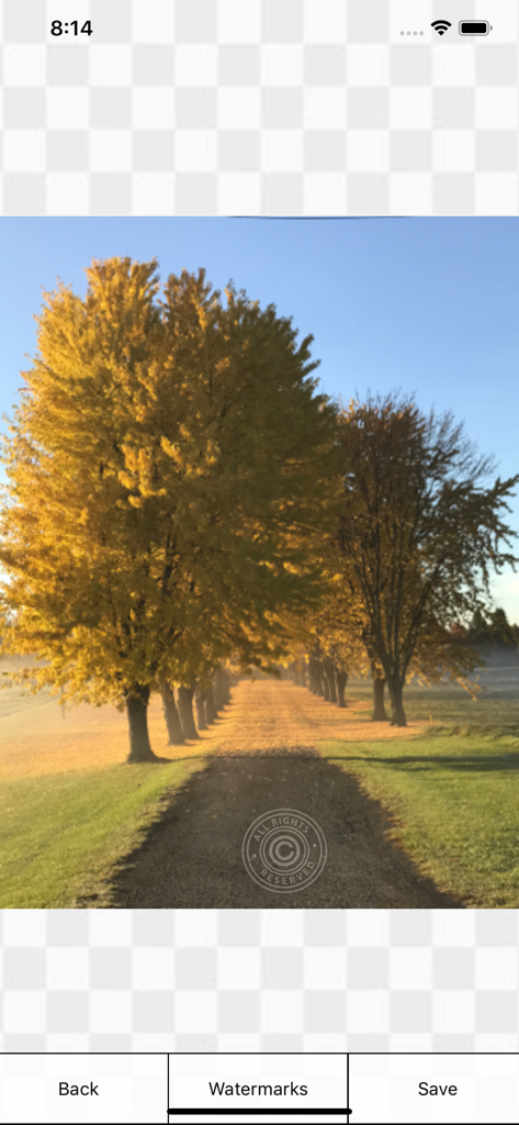 A scenic autumn landscape photo with an All Rights Reserved copyright watermark applied using the iWatermark Lite mobile app interface.