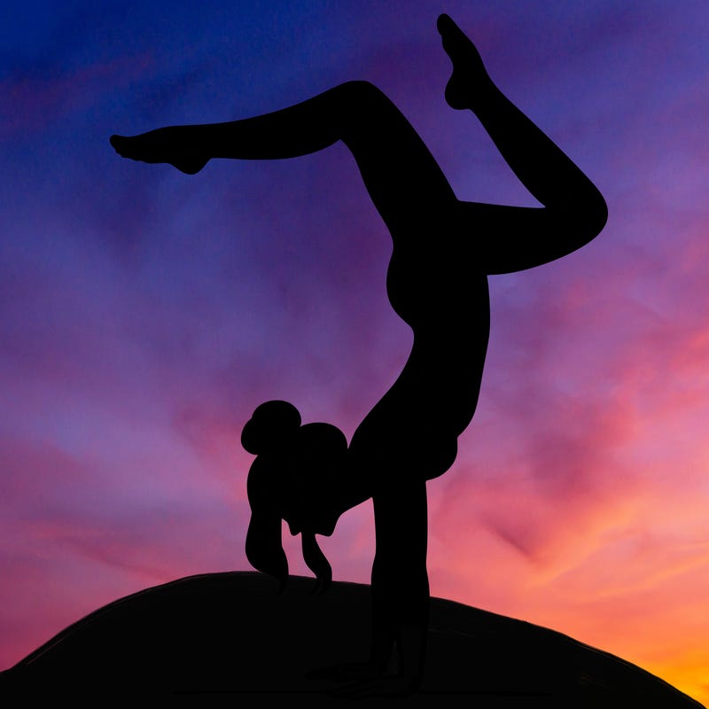 a woman doing a handstand