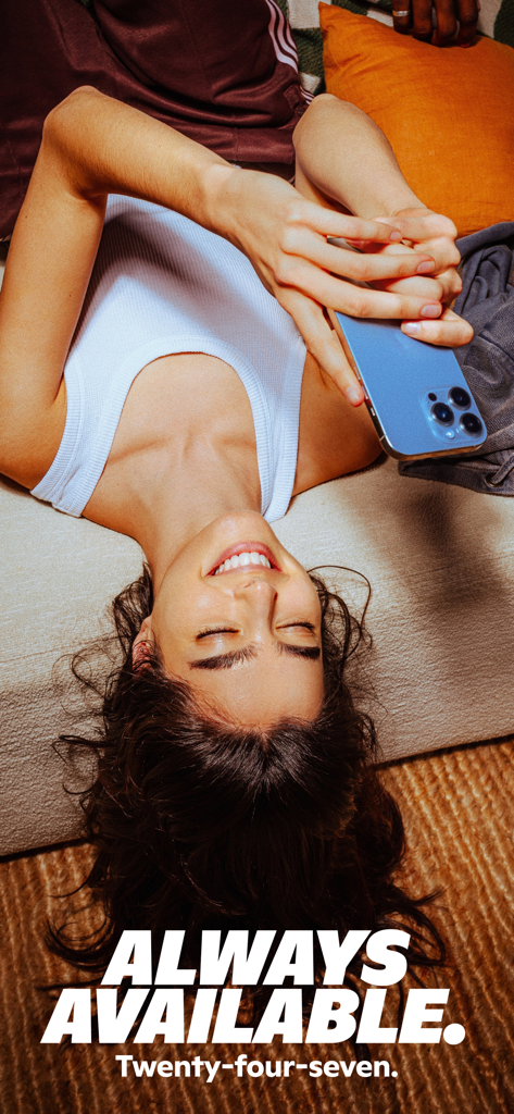 A person smiling and using a smartphone with text saying always available twenty four seven