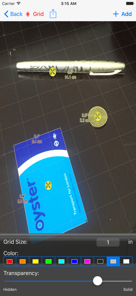 Interfaz de la aplicación Photo Meter midiendo un bolígrafo y una moneda usando una tarjeta de referencia