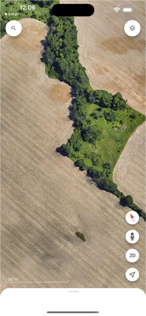 Google Earth satellite view showing a strip of green trees between dry agricultural fields