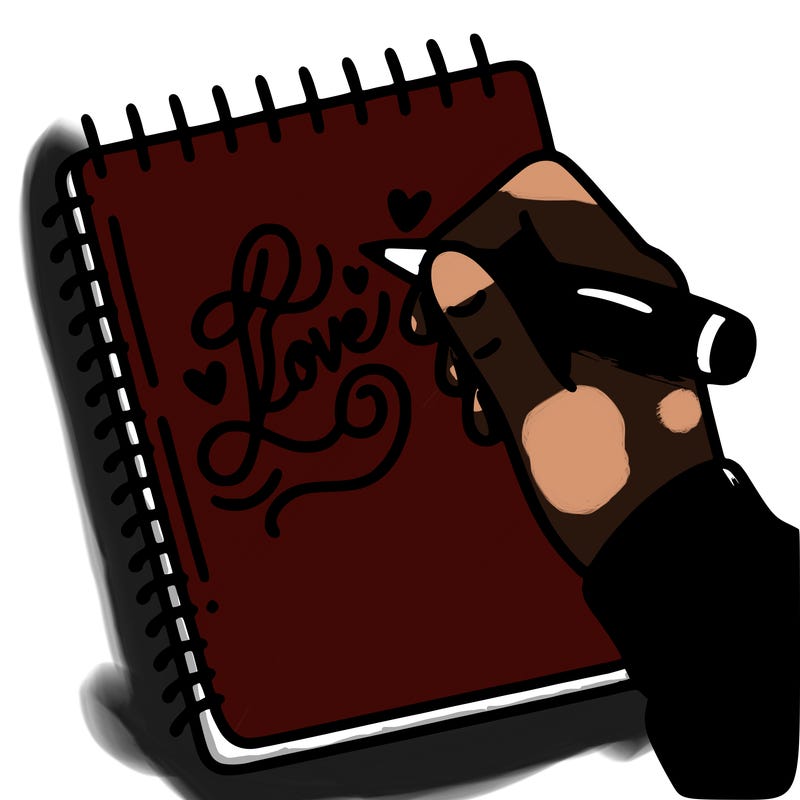 a hand writing “love” in calligraphy on a notebook