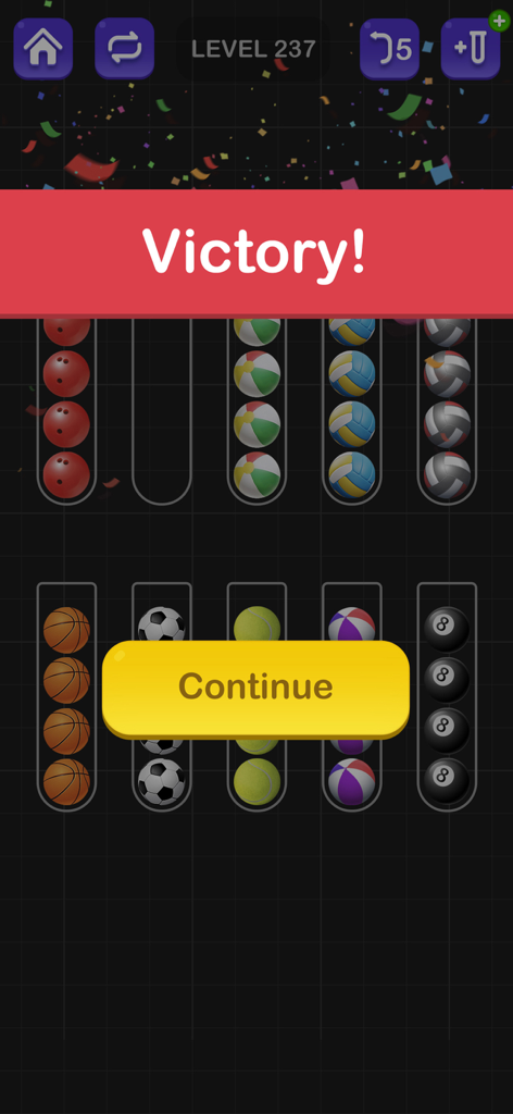 Victory message on a mobile puzzle game screen with sorted balls in glass tubes