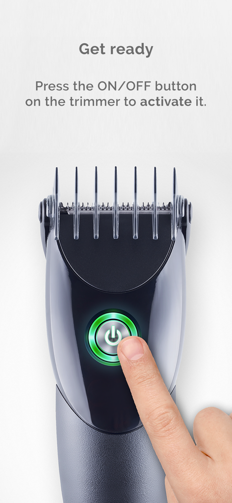 A digital hair trimmer with a finger pressing the glowing green power button to start the prank simulator.