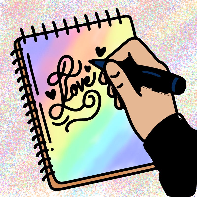 a hand writing “love” in calligraphy on a notebook