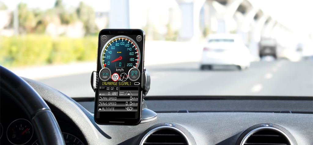 Smartphone mounted on a car dashboard showing the Speedmeter plus app with speed and trip data