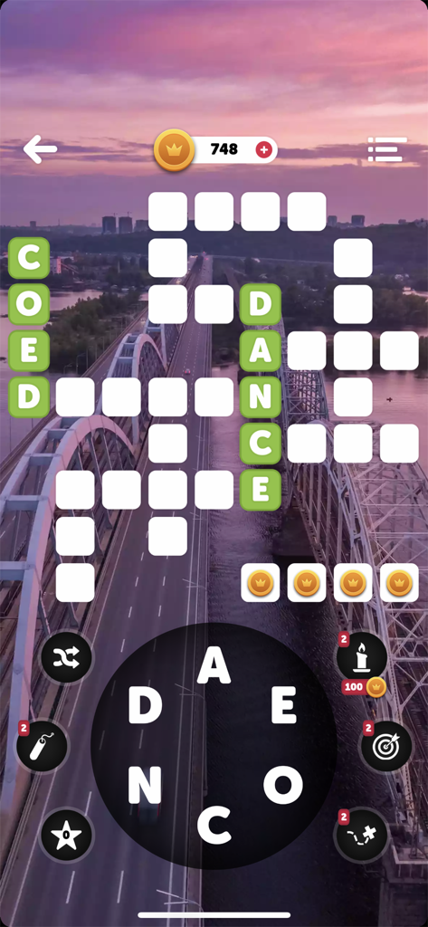 Words of the World! - A crossword puzzle interface from Words of the World showing a word swipe wheel and a scenic bridge background at sunset