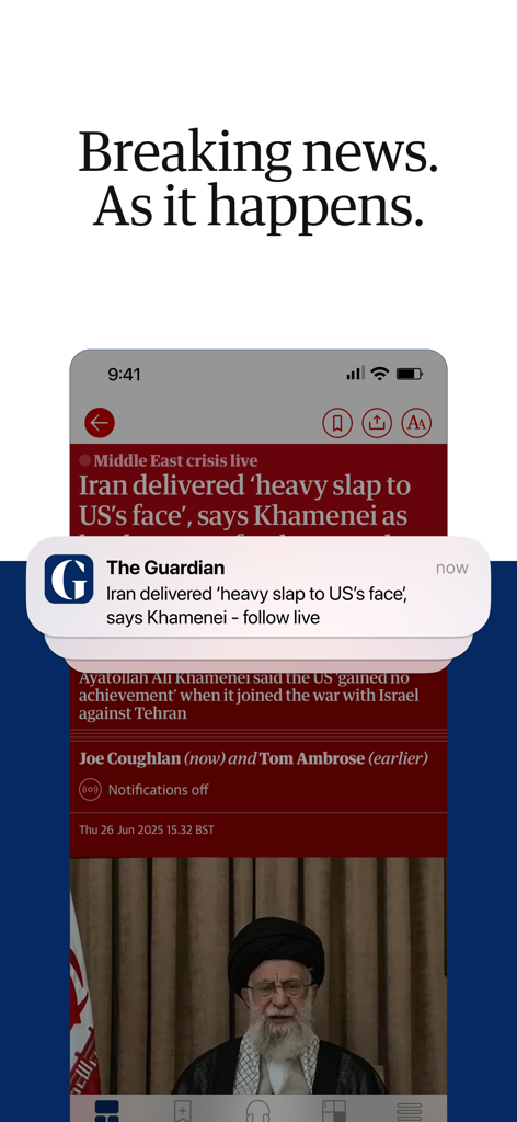A smartphone showing The Guardian app with a live news blog and a push notification