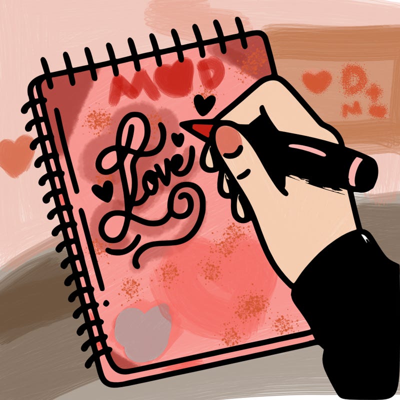 a hand writing “love” in calligraphy on a notebook
