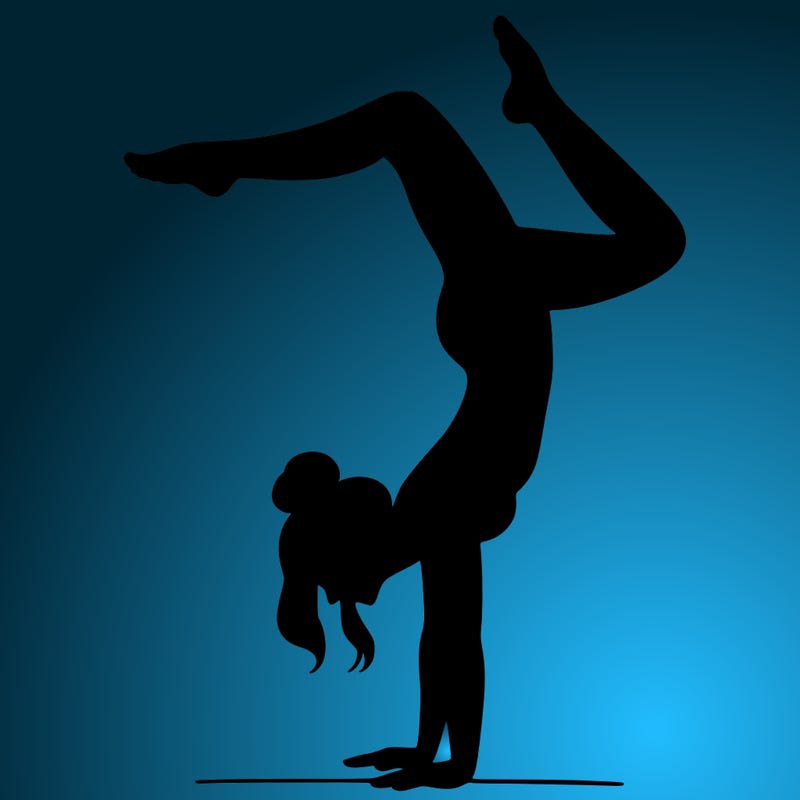 a woman doing a handstand